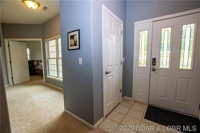 entrance foyer featuring light tile floors