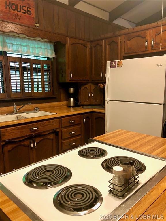 kitchen featuring white fridge and sink