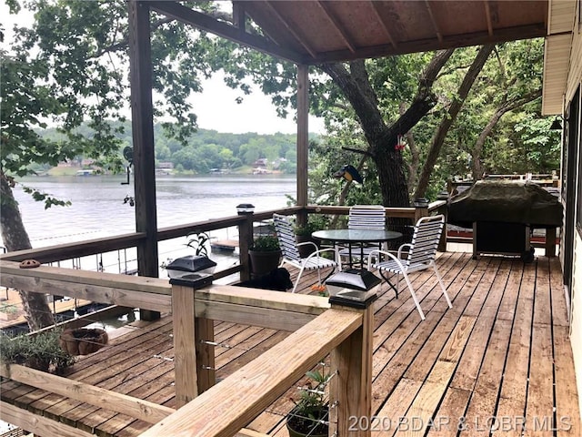 wooden terrace featuring a water view