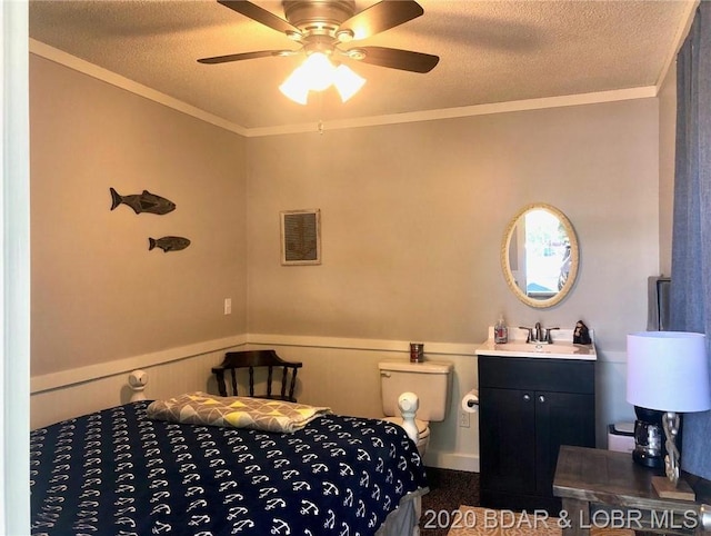 carpeted bedroom with ornamental molding, ceiling fan, and a textured ceiling