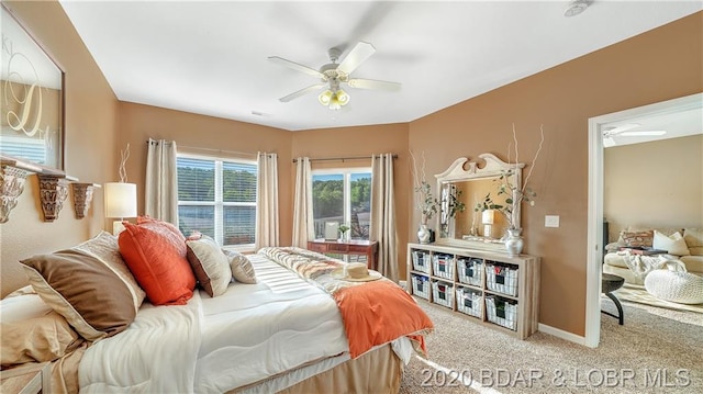 bedroom with light carpet and ceiling fan