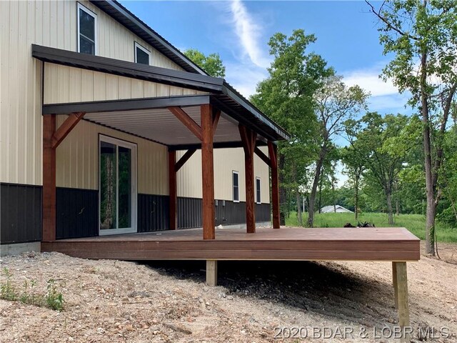 back of property with a wooden deck