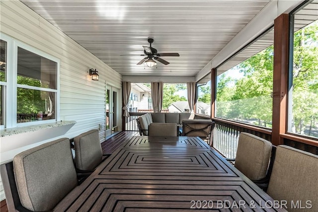 sunroom / solarium featuring ceiling fan