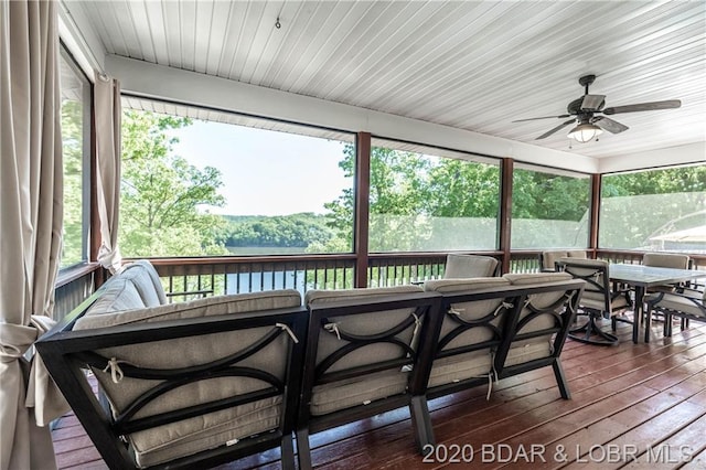 sunroom with wooden ceiling and ceiling fan