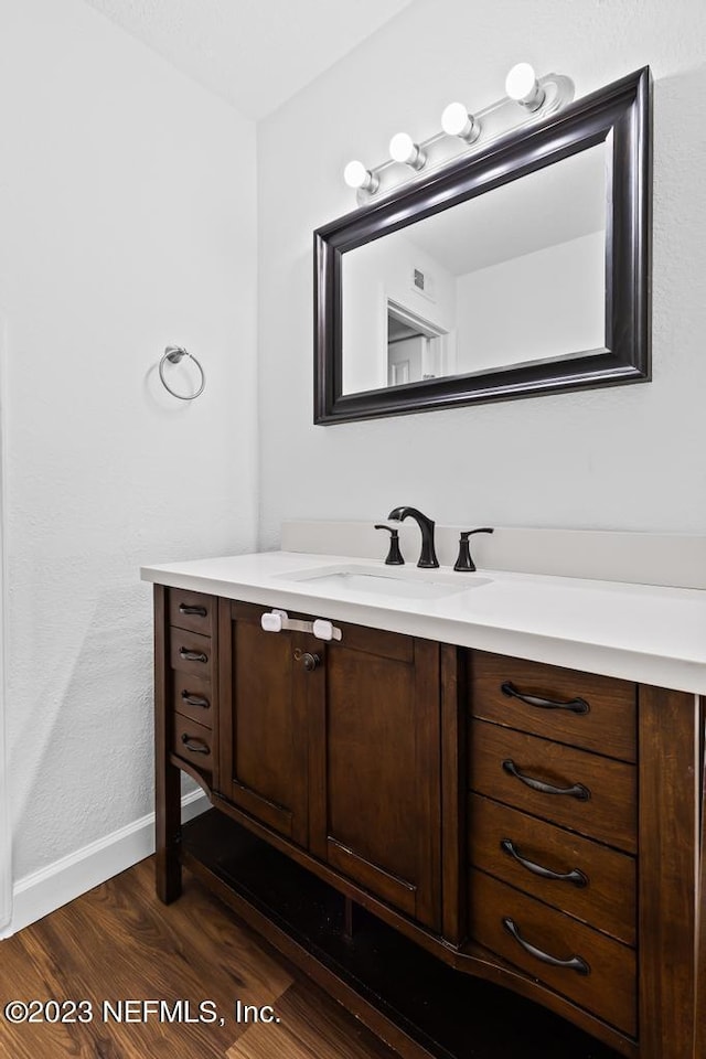 bathroom featuring wood-type flooring and vanity