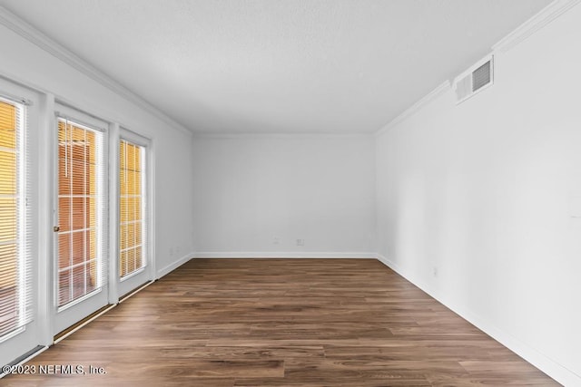 empty room with crown molding and dark hardwood / wood-style flooring