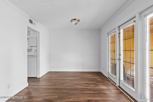 spare room featuring crown molding and dark hardwood / wood-style flooring