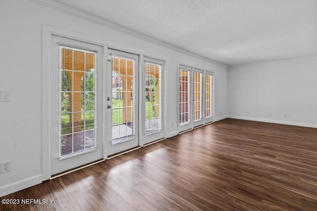 entryway featuring ornamental molding, plenty of natural light, and dark hardwood / wood-style floors