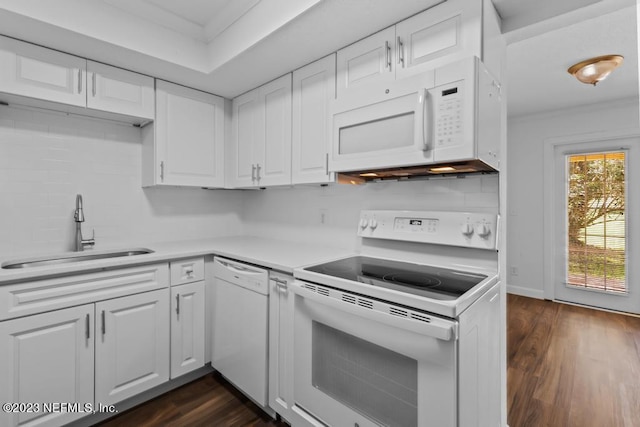 kitchen with dark hardwood / wood-style flooring, white cabinets, sink, and white appliances