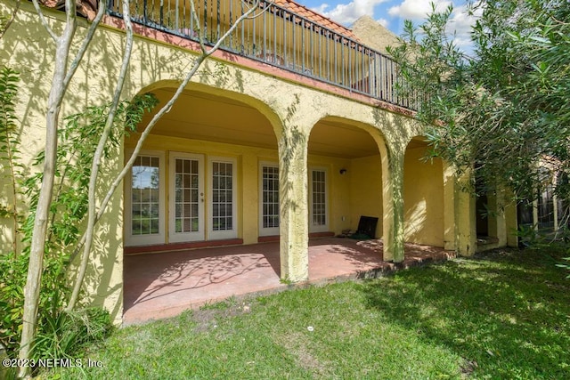 back of house with a patio and a yard