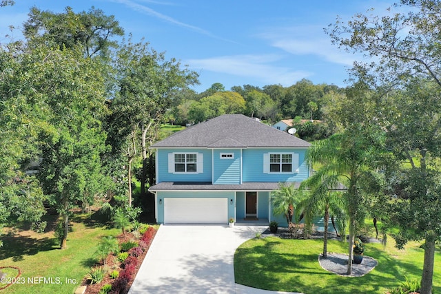 view of front of house featuring a garage and a front lawn