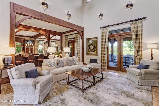 living room featuring french doors and beam ceiling