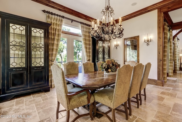 dining room featuring a notable chandelier, crown molding, and french doors