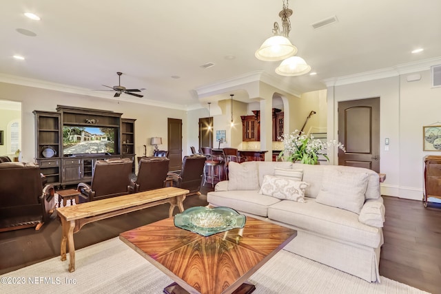 living room featuring ornamental molding, hardwood / wood-style flooring, and ceiling fan