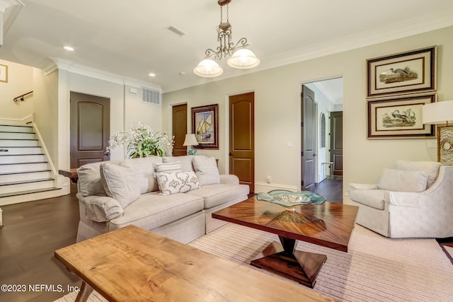 living room featuring ornamental molding, a notable chandelier, and wood-type flooring