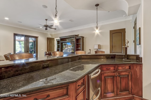 kitchen featuring hanging light fixtures, ornamental molding, and dark stone countertops