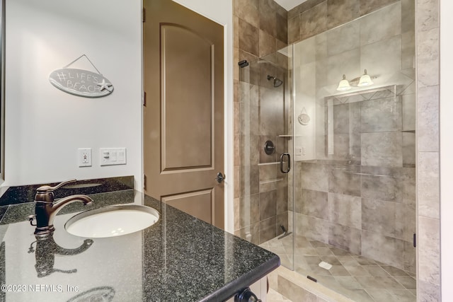 bathroom with a shower with door and vanity