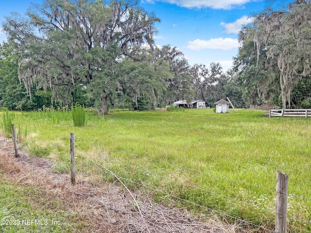 view of yard with a rural view