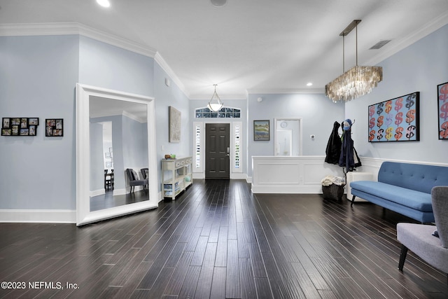 foyer entrance with a notable chandelier, dark hardwood / wood-style flooring, and crown molding