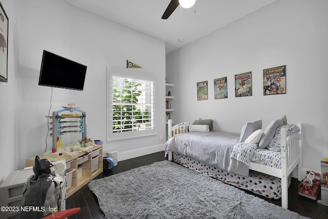 bedroom featuring ceiling fan, dark wood-type flooring, and vaulted ceiling