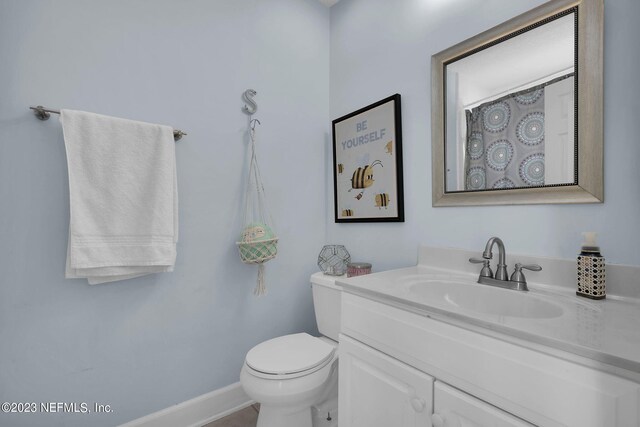 bathroom featuring vanity and toilet