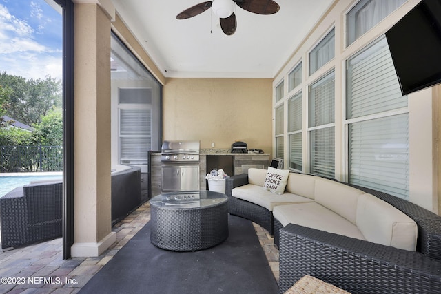 view of patio / terrace with an outdoor hangout area, ceiling fan, exterior kitchen, and grilling area