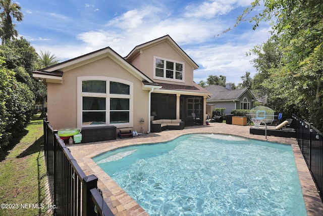 view of swimming pool featuring a patio area, a sunroom, and an outdoor hangout area