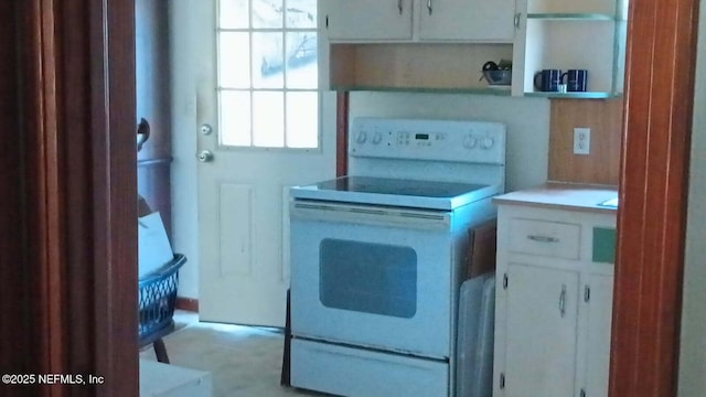 kitchen with electric range and white cabinets