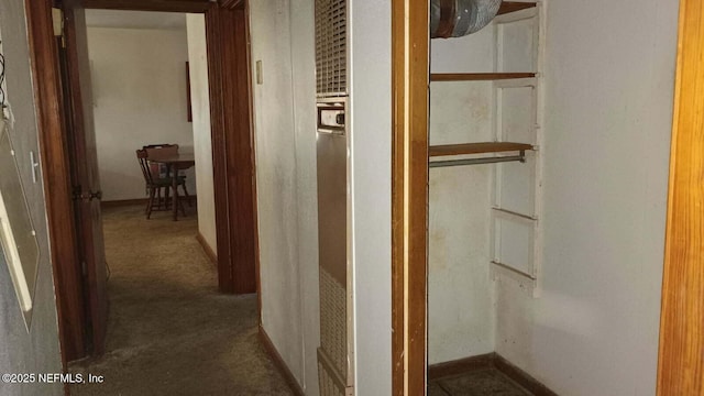 corridor with dark colored carpet