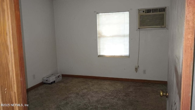 carpeted spare room with an AC wall unit