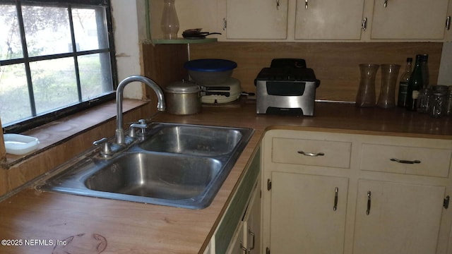 kitchen with sink and white cabinets