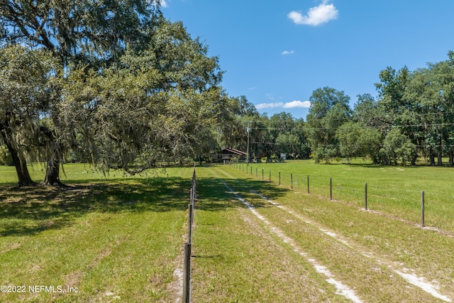 view of yard with a rural view