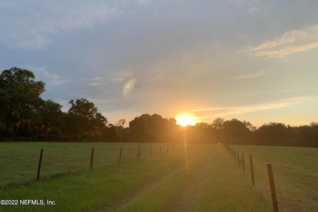 yard at dusk with a rural view