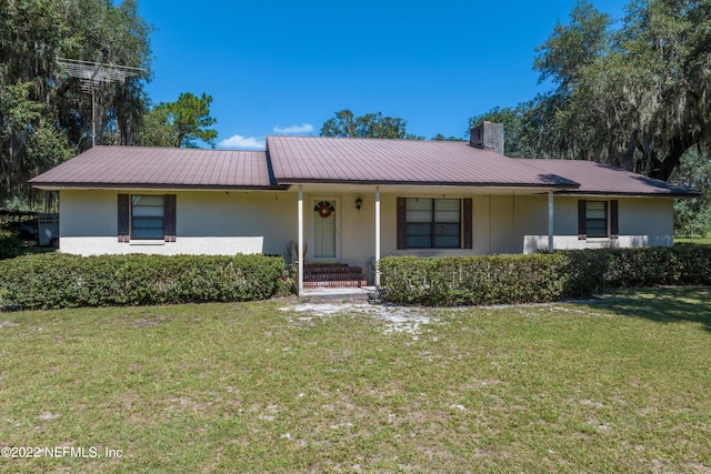 ranch-style home featuring a front yard and a porch