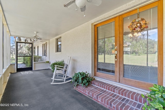 unfurnished sunroom featuring ceiling fan