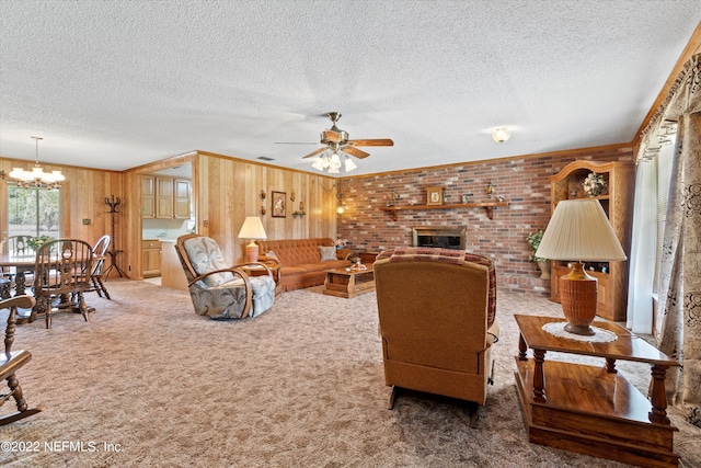 living room with carpet floors, wood walls, and a textured ceiling