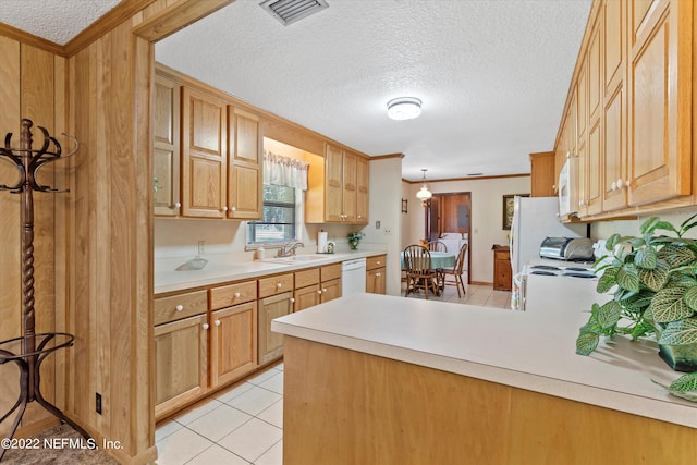 kitchen featuring light tile patterned flooring, ornamental molding, sink, kitchen peninsula, and white appliances