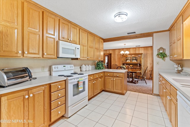 kitchen with white appliances, kitchen peninsula, pendant lighting, a chandelier, and a textured ceiling