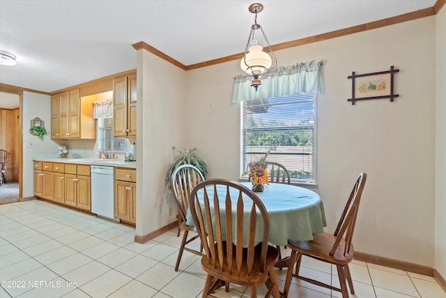 tiled dining area featuring ornamental molding, sink, and a textured ceiling