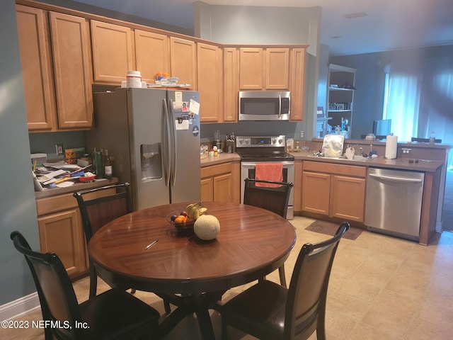 kitchen with light tile patterned flooring and stainless steel appliances