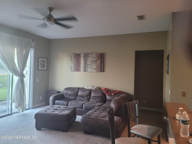 carpeted living room with ceiling fan