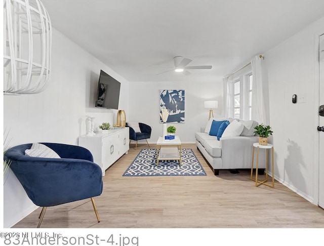 living room featuring ceiling fan and light wood-type flooring