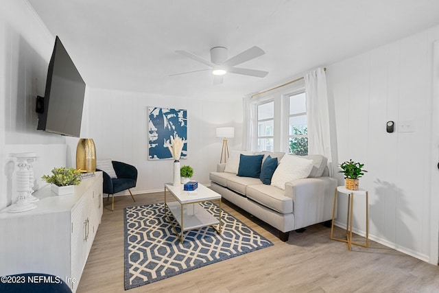 living room featuring ceiling fan and light wood-type flooring