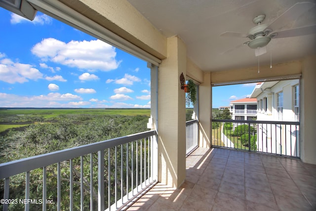 balcony featuring a rural view and ceiling fan