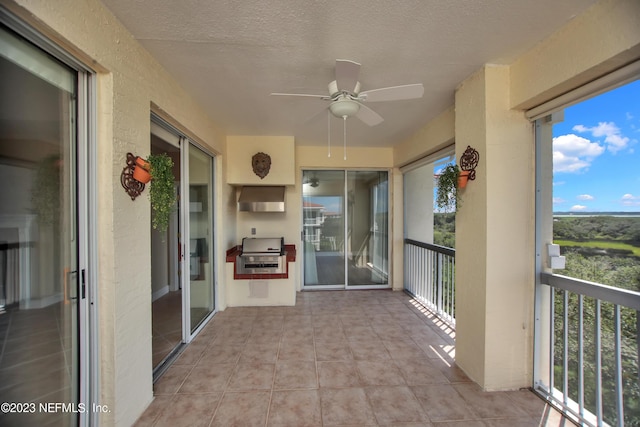 unfurnished sunroom with ceiling fan and plenty of natural light