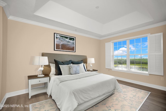 bedroom featuring crown molding, a tray ceiling, and dark hardwood / wood-style floors