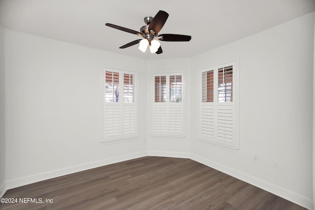 empty room featuring dark wood-type flooring and ceiling fan