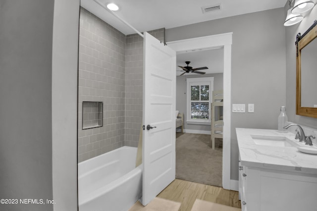 bathroom featuring hardwood / wood-style floors, vanity, ceiling fan, and bathtub / shower combination