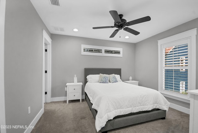 bedroom featuring dark colored carpet and ceiling fan