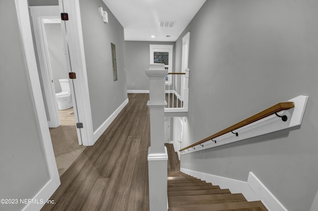 staircase with hardwood / wood-style floors